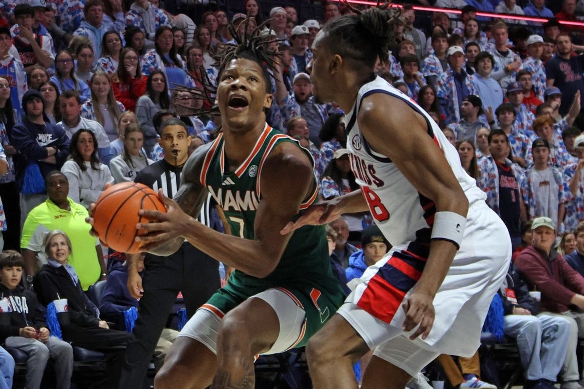 Dec 2, 2025; Oxford, Mississippi, USA; Miami Hurricanes forward Shelton Henderson (7) drives to the basket as Mississippi Rebels forward Augusto Cassiá (88) defends during the first half at The Sandy and John Black Pavilion at Ole Miss. Mandatory Credit: Petre Thomas-Imagn Images