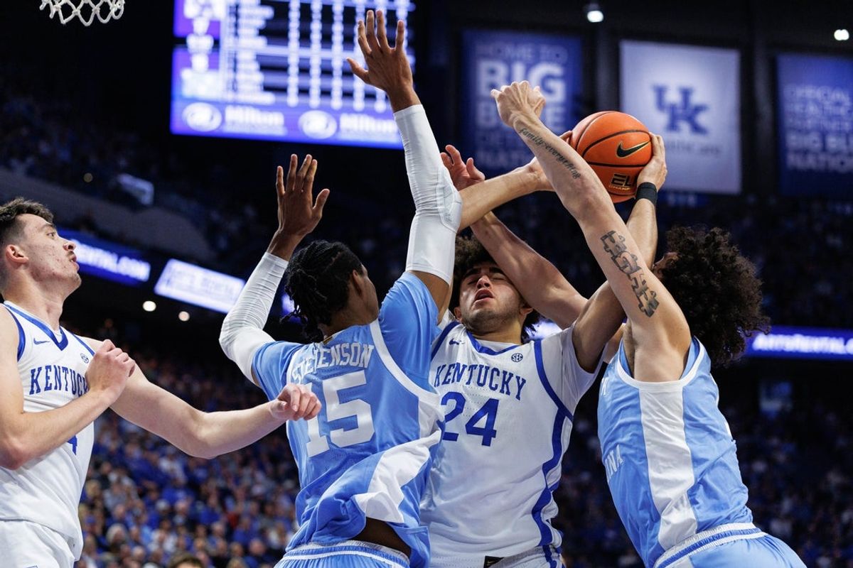 Dec 2, 2025; Lexington, Kentucky, USA; Kentucky Wildcats center Malachi Moreno (24) attempts to grab the rebound against North Carolina Tar Heels forwards Jarin Stevenson (15) and Zayden High (1) during the first half at Rupp Arena at Central Bank Center. Mandatory Credit: Jordan Prather-Imagn Images