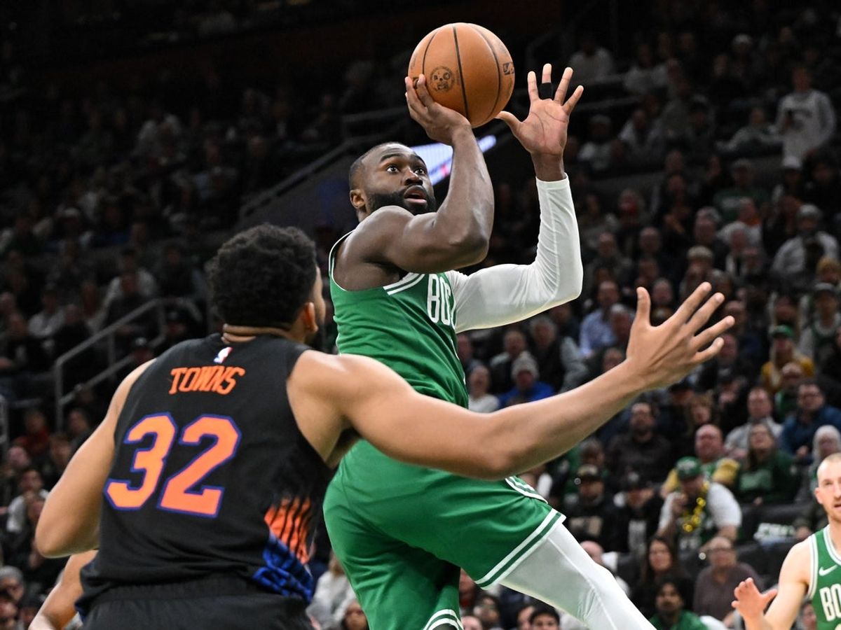 Dec 2, 2025; Boston, Massachusetts, USA; Boston Celtics guard Jaylen Brown (7) attempts a basket against New York Knicks center Karl-Anthony Towns (32) during the second half at the TD Garden. Mandatory Credit: Brian Fluharty-Imagn Images