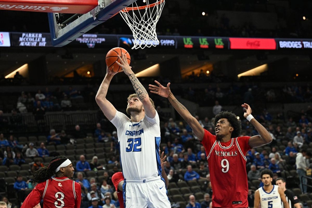 Dec 2, 2025; Omaha, Nebraska, USA;  Creighton Bluejays forward Owen Freeman (32) scores against Nicholls State Colonels guard Zaiden Cross (9) during the second half at CHI Health Center Omaha. Mandatory Credit: Steven Branscombe-Imagn Images
