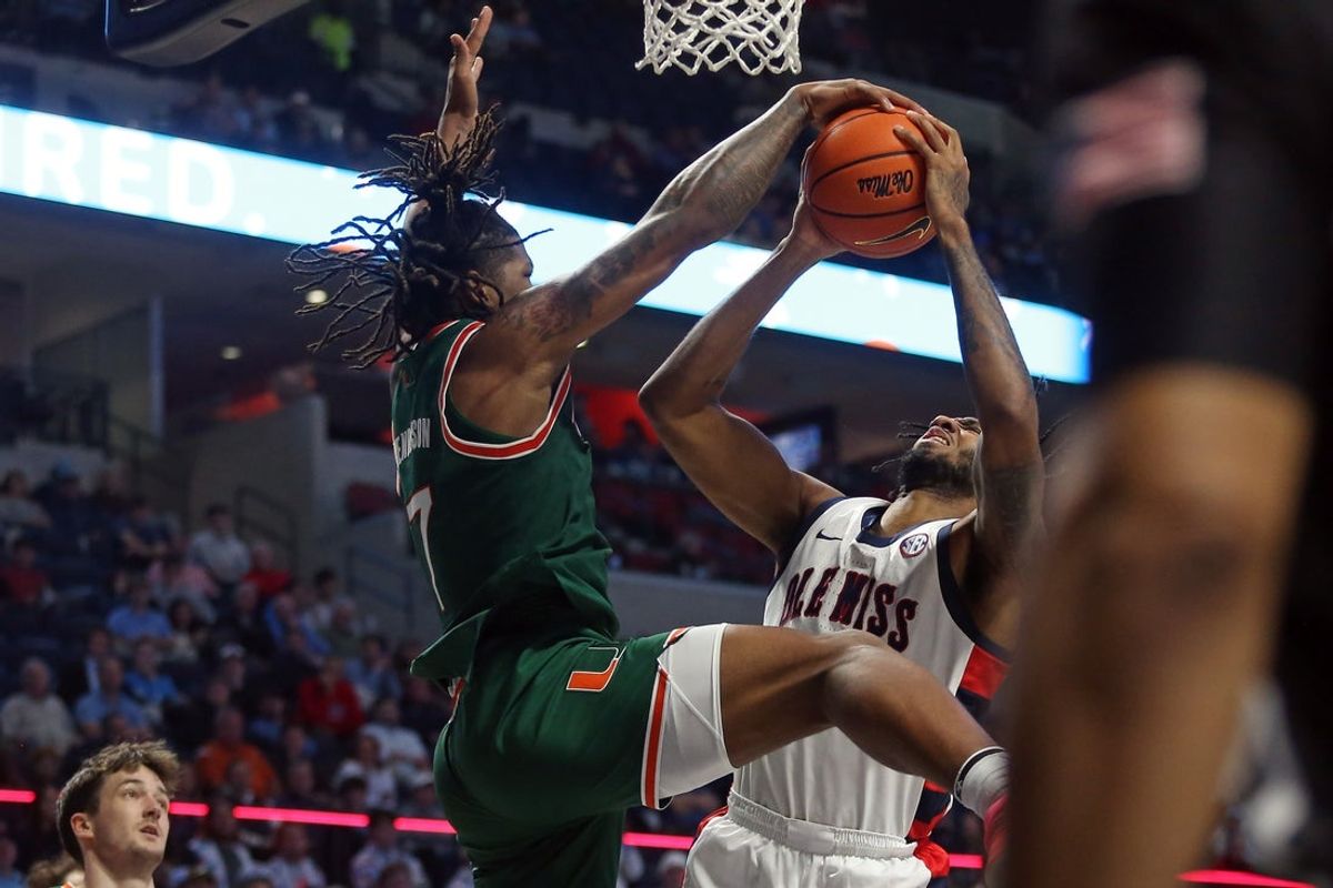 Dec 2, 2025; Oxford, Mississippi, USA; Miami Hurricanes forward Shelton Henderson (7) bloocks a shot attempt by Mississippi Rebels forward James Scott (4) during the second half at The Sandy and John Black Pavilion at Ole Miss. Mandatory Credit: Petre Thomas-Imagn Images