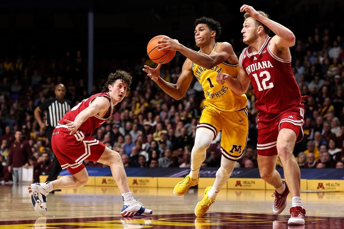 Dec 3, 2025; Minneapolis, Minnesota, USA; Minnesota Golden Gophers guard Isaac Asuma (1) drives towards the basket as Indiana Hoosiers forward Tucker Devries (12) defends during the first half at Williams Arena. Mandatory Credit: Matt Krohn-Imagn Images