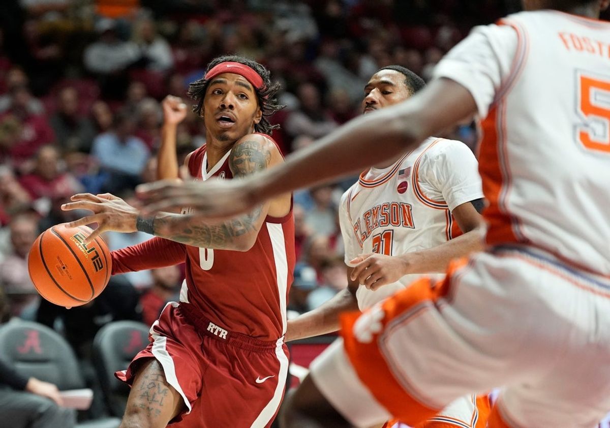 Dec 3, 2025; Tuscaloosa, AL, USA; Alabama guard Labaron Philon Jr. (0) drives against Clemson guard Ace Buckner (21) and Clemson guard Zac Foster (5) at Coleman Coliseum. Mandatory Credit: Gary Cosby Jr.-Tuscaloosa News