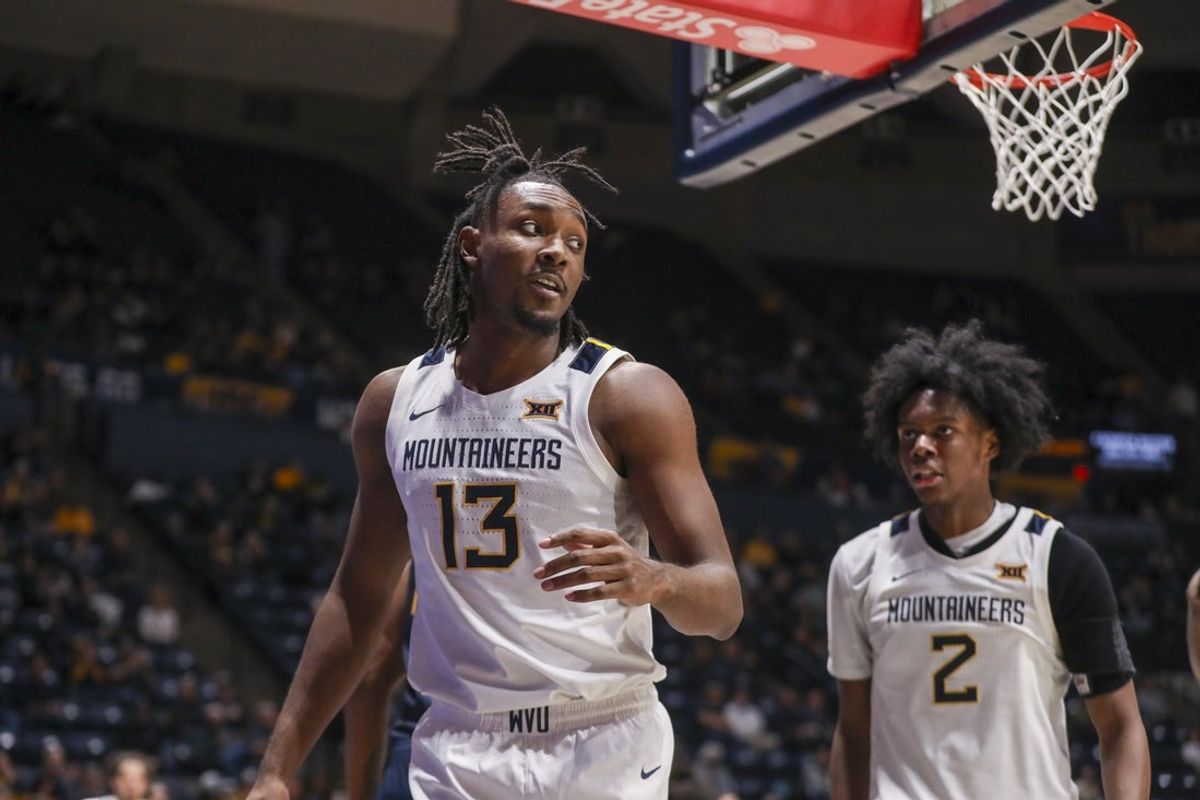 Dec 3, 2025; Morgantown, West Virginia, USA; West Virginia Mountaineers guard Chance Moore (13) celebrates after a play during the second half against the Coppin State Eagles at Hope Coliseum. Mandatory Credit: Ben Queen-Imagn Images