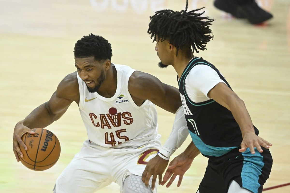 Dec 3, 2025; Cleveland, Ohio, USA; Cleveland Cavaliers guard Donovan Mitchell (45) dribbles against Portland Trail Blazers guard Shaedon Sharpe (17) in the fourth quarter at Rocket Arena. Mandatory Credit: David Richard-Imagn Images