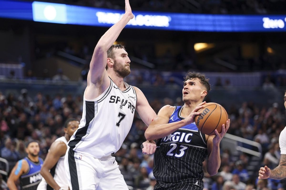Dec 3, 2025; Orlando, Florida, USA; Orlando Magic forward Tristan da Silva (23) drives to the basket past San Antonio Spurs center Luke Kornet (7) in the third quarter at Kia Center. Mandatory Credit: Nathan Ray Seebeck-Imagn Images