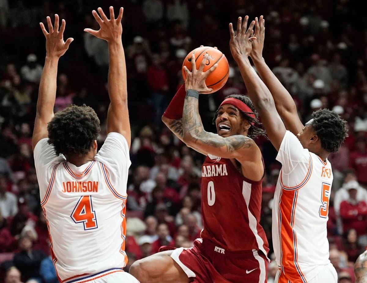 Dec 3, 2025; Tuscaloosa, AL, USA; Alabama guard Labaron Philon Jr. (0) goes for a shot between Clemson guard Butta Johnson (4) and Clemson guard Zac Foster (5) at Coleman Coliseum. Alabama defeated Clemson 90-84. Mandatory Credit: Gary Cosby Jr.-Tuscaloosa News