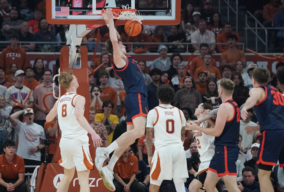 Dec 3, 2025; Austin, Texas, USA; Virginia Cavaliers center Johann Grunloh (17) dunks against Texas Longhorns center Matas Vokietaitis (8) during the first half at Moody Center. Mandatory Credit: Dustin Safranek-Imagn Images