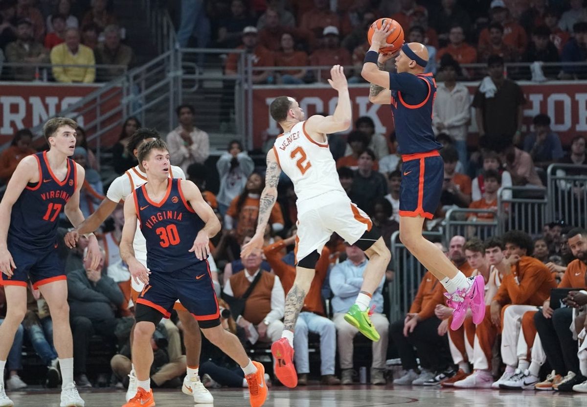 Dec 3, 2025; Austin, Texas, USA; Virginia Cavaliers guard Jacari White (6) shoots a three point basket against Texas Longhorns guard Chendall Weaver (2) during the first half at Moody Center. Mandatory Credit: Dustin Safranek-Imagn Images
