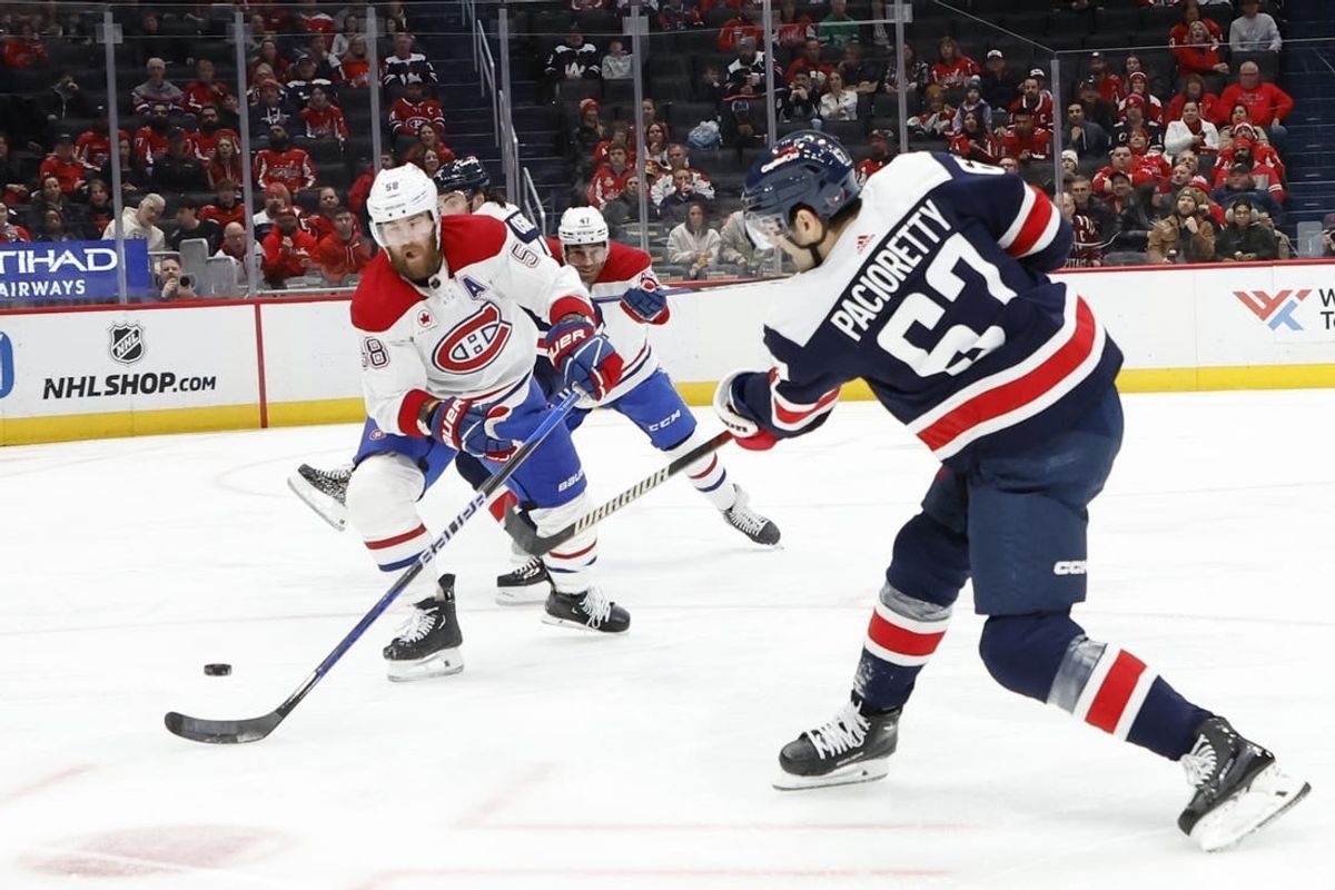 Feb 6, 2024; Washington, District of Columbia, USA; Washington Capitals left wing Max Pacioretty (67) shoots the puck as Montreal Canadiens defenseman David Savard (58) defends in the first period at Capital One Arena.