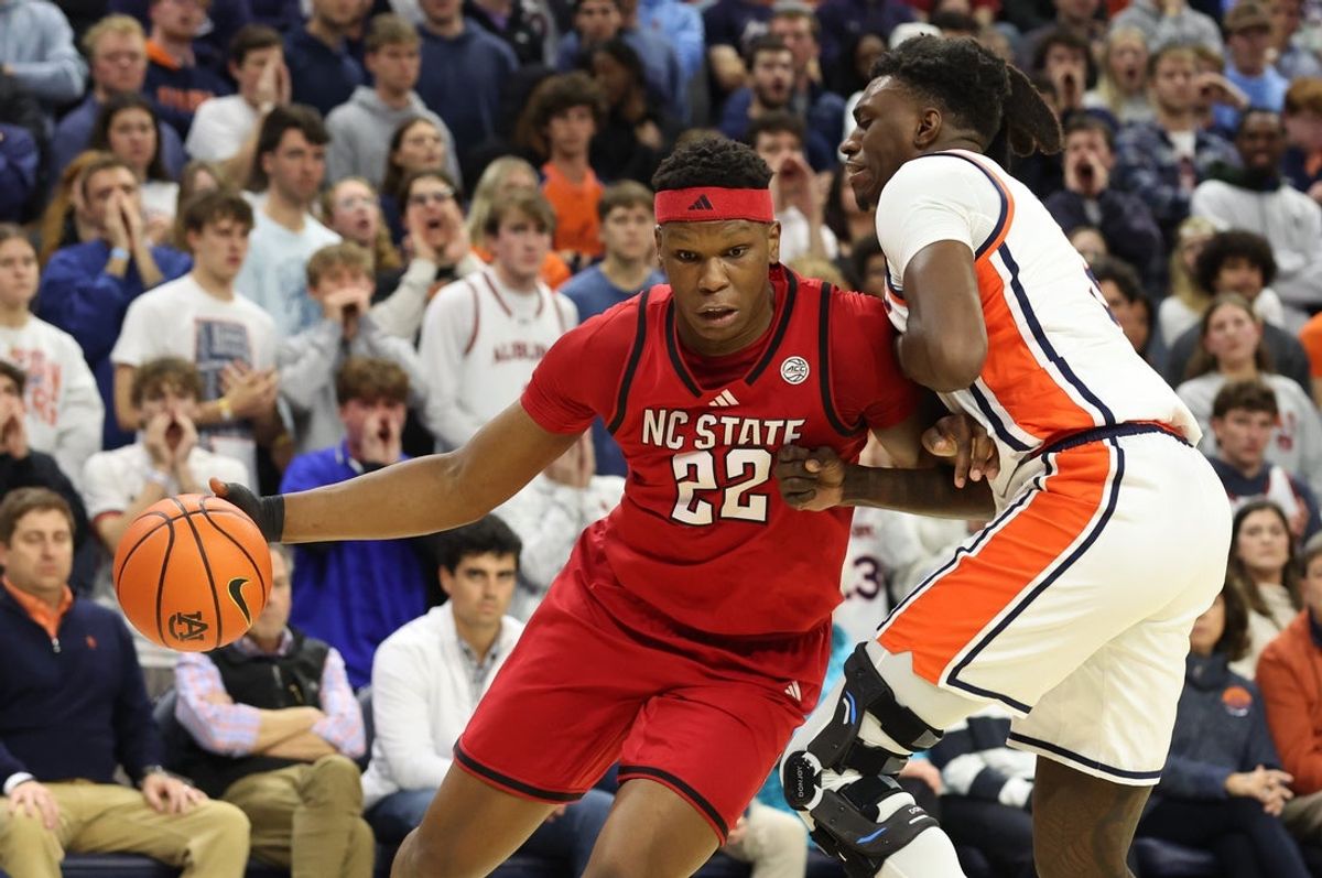 Dec 3, 2025; Auburn, Alabama, USA;  NC State Wolfpack forward Ven-Allen Lubin (22) is pressured by Auburn Tigers forward Keshawn Murphy (3) during the first half fat Neville Arena. Mandatory Credit: John Reed-Imagn Images