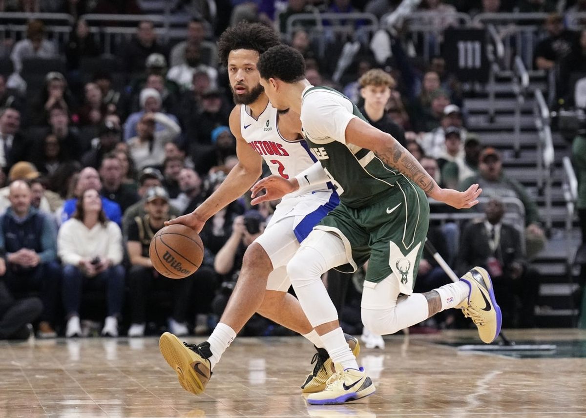 Dec 3, 2025; Milwaukee, Wisconsin, USA;  Detroit Pistons guard Cade Cunningham (2) brings the ball up the court against Milwaukee Bucks guard Ryan Rollins (13) in the second half at Fiserv Forum. Mandatory Credit: Michael McLoone-Imagn Images