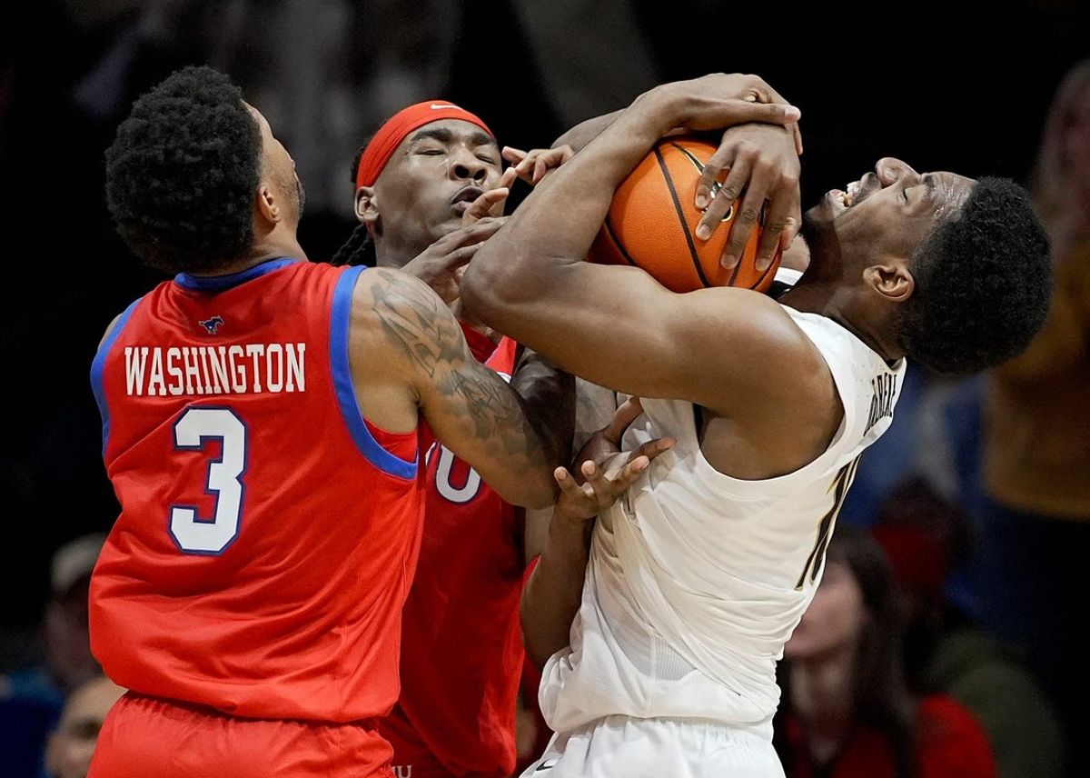 Vanderbilt forward Ak Okereke (10) grabs the ball away from SMU’s forward Corey Washington (3) and Jaden Toombs (10) during the second half of an NCAA college basketball game Wednesday, Dec. 3, 2025, in Nashville, Tenn. Vanderbilt won 88-69.