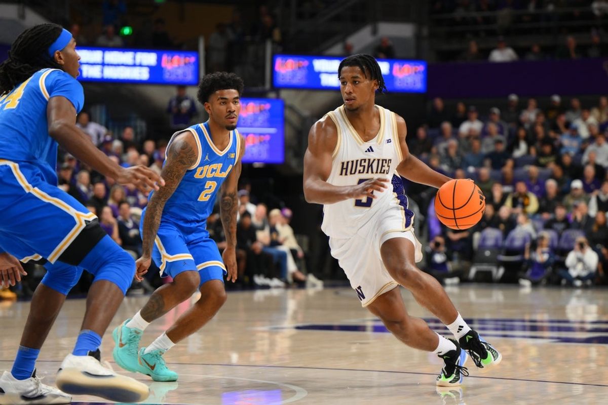 Dec 3, 2025; Seattle, Washington, USA; Washington Huskies guard Zoom Diallo (5) dribbles towards the basket while guarded by UCLA Bruins guard Donovan Dent (2) during the first half at Alaska Airlines Arena at Hec Edmundson Pavilion. Mandatory Credit: Steven Bisig-Imagn Images
