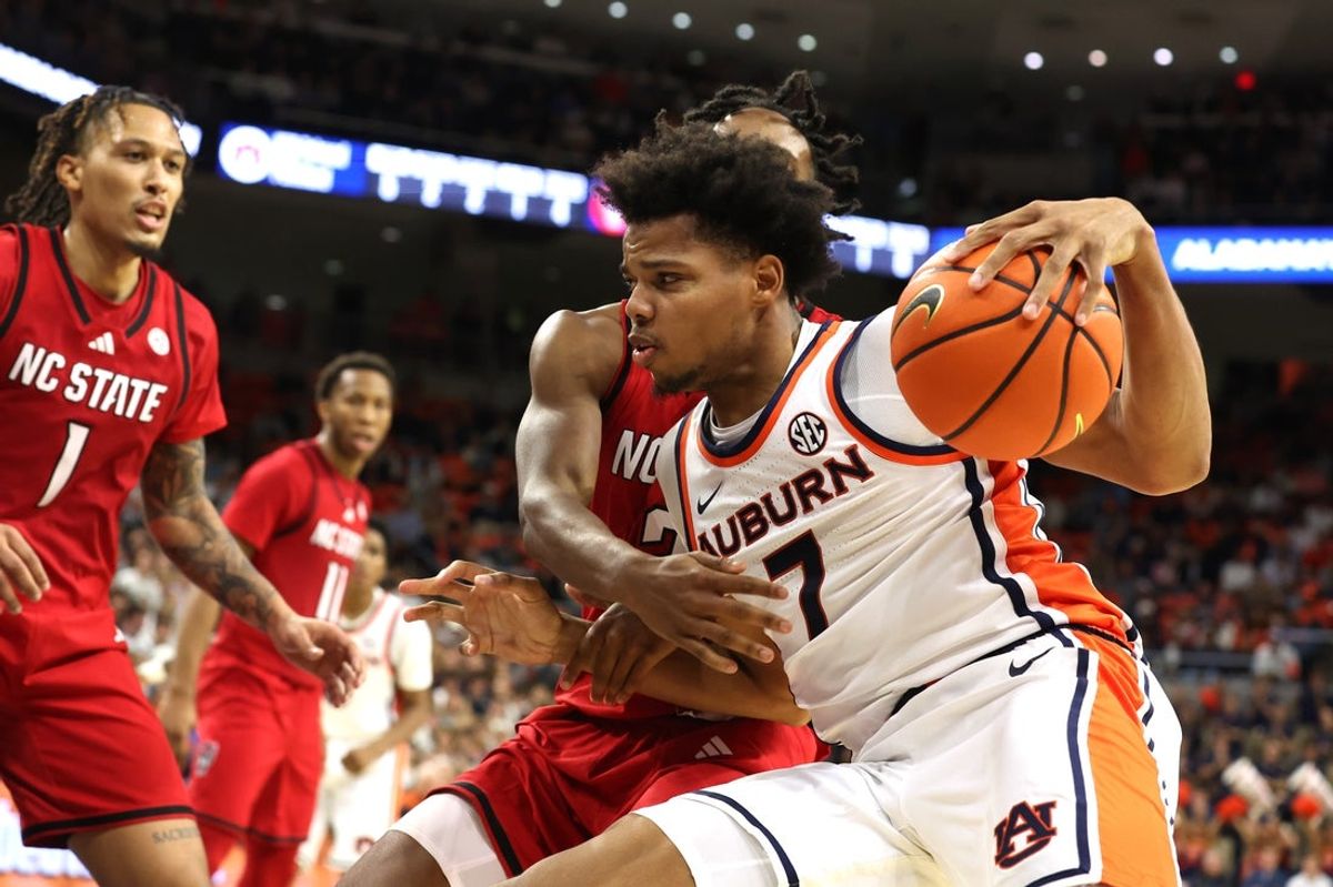Dec 3, 2025; Auburn, Alabama, USA;  Auburn Tigers guard Keyshawn Hall (7) gets tangled up with NC State Wolfpack guard Jr. Paul McNeil (2) during the second half at Neville Arena. Mandatory Credit: John Reed-Imagn Images