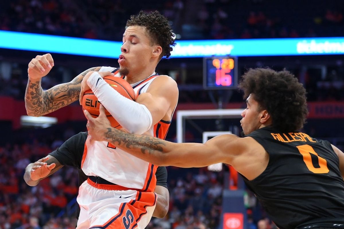 Dec 2, 2025; Syracuse, New York, USA; Syracuse Orange guard Nate Kingz (left) drives as Tennessee Volunteers guard Ja’Kobi Gillespie (right) reaches for the ball during the second half at the JMA Wireless Dome. Mandatory Credit: Rich Barnes-Imagn Images