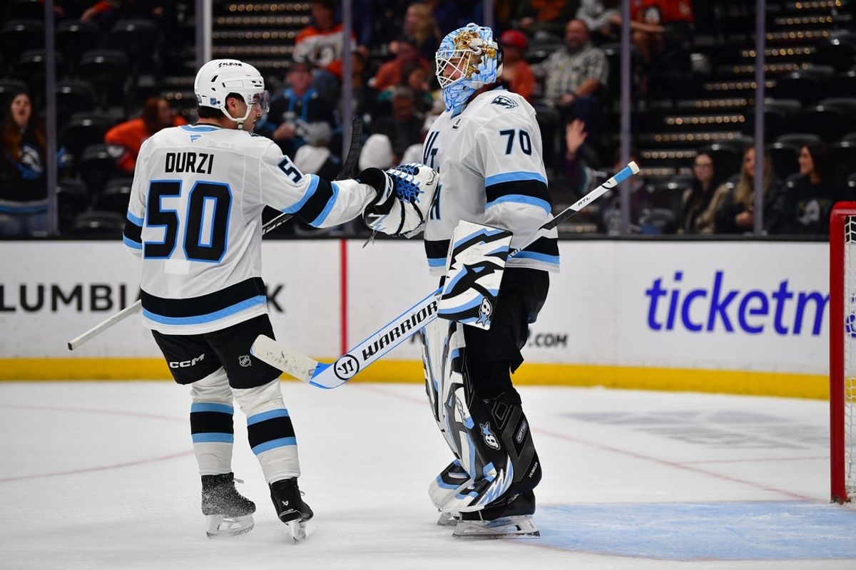 Dec 3, 2025; Anaheim, California, USA; Utah Mammoth defeseman Sean Durzi (50) and goaltender Karel Vejmelka (70) celebrate the victory against the Anaheim Ducks at Honda Center. Mandatory Credit: Gary A. Vasquez-Imagn Images