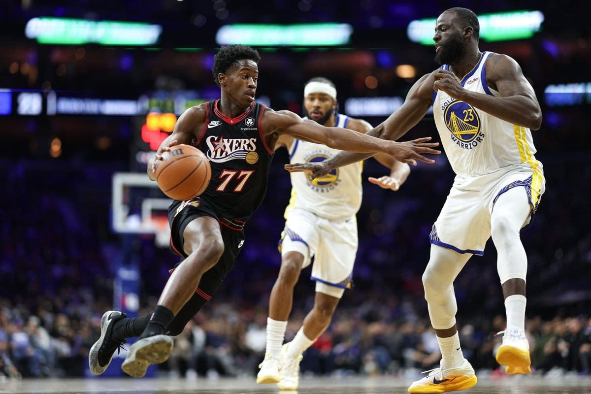 Dec 4, 2025; Philadelphia, Pennsylvania, USA; Philadelphia 76ers guard VJ Edgecombe (77) drives against Golden State Warriors forward Draymond Green (23) during the second quarter at Xfinity Mobile Arena. Mandatory Credit: Bill Streicher-Imagn Images
