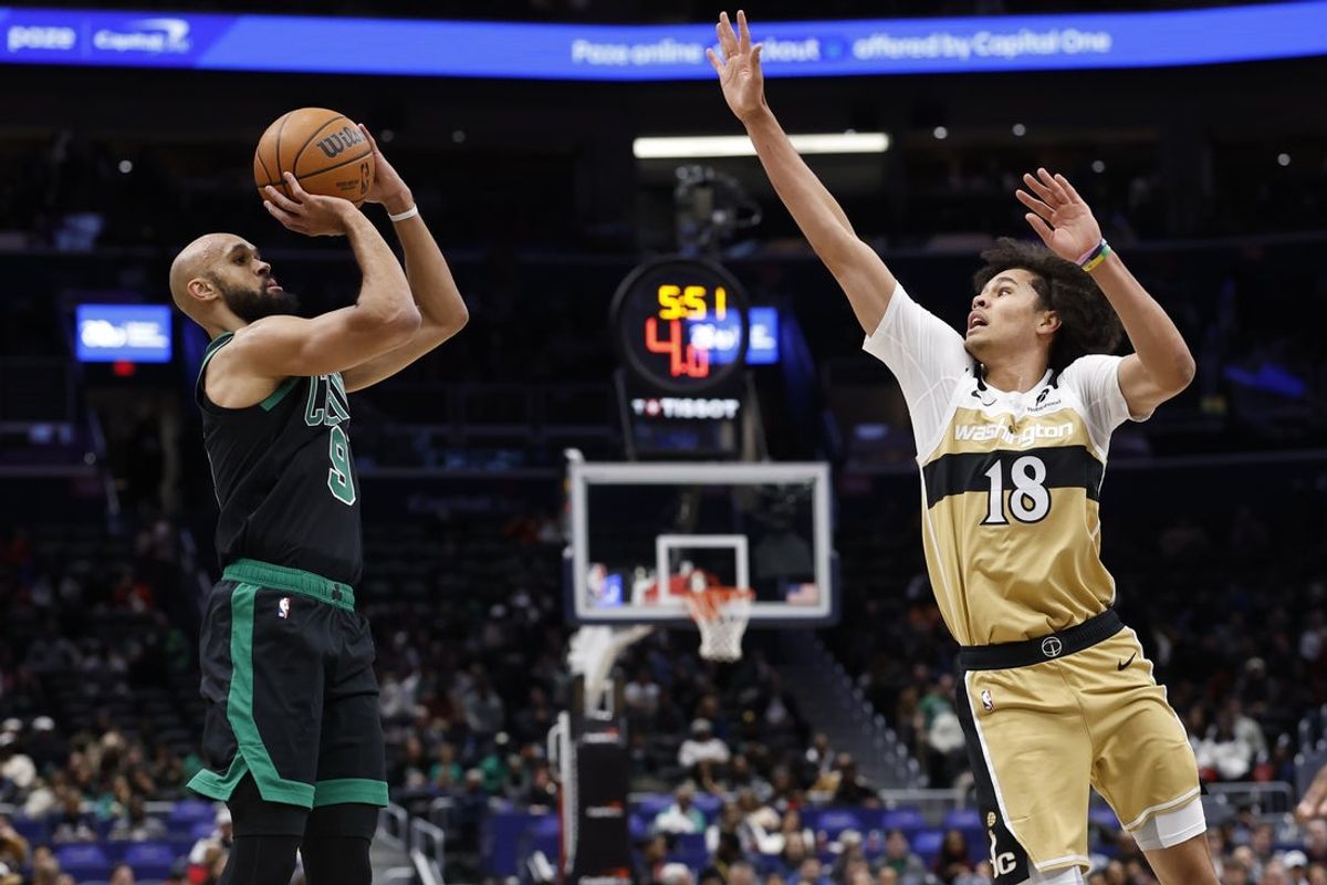Dec 4, 2025; Washington, District of Columbia, USA; Boston Celtics guard Derrick White (9) shoots the ball as Washington Wizards forward Kyshawn George (18) defends in the first half at Capital One Arena. Mandatory Credit: Geoff Burke-Imagn Images