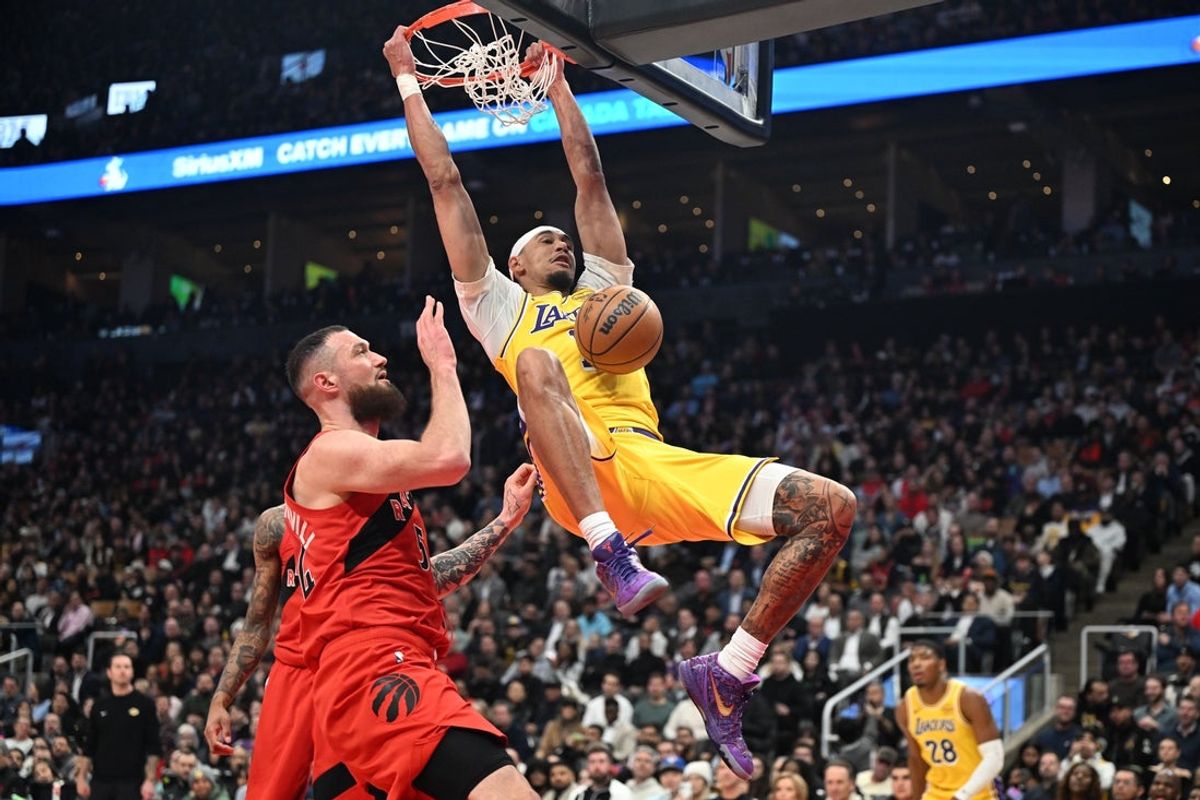 Dec 4, 2025; Toronto, Ontario, CAN;  Los Angeles Lakers center Jaxson Hayes (11) dunks for a basket over Toronto Raptors center Sandro Mamukelashvili (54) in the first half at Scotiabank Arena. Creditt: Dan Hamilton-Imagn Images