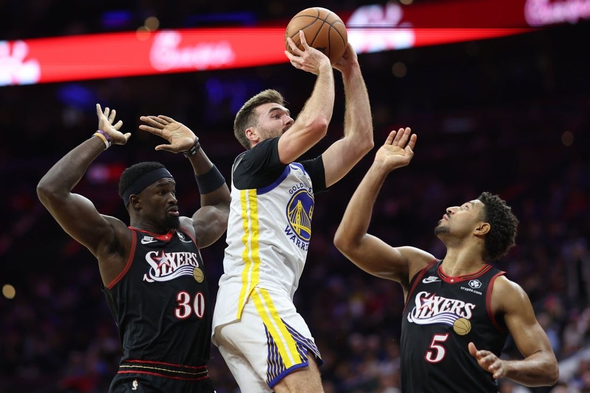 Dec 4, 2025; Philadelphia, Pennsylvania, USA; Golden State Warriors guard Pat Spencer (61) drives for a shot between Philadelphia 76ers center Adem Bona (30) and guard Quentin Grimes (5) during the fourth quarter at Xfinity Mobile Arena. Mandatory Credit: Bill Streicher-Imagn Images