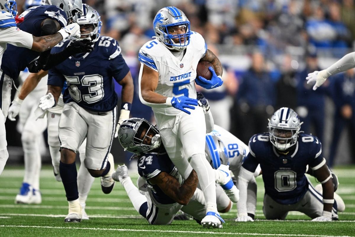 Dec 4, 2025; Detroit, Michigan, USA; Detroit Lions running back David Montgomery (5) runs against Dallas Cowboys cornerback Shavon Revel Jr. (34) during the first half at Ford Field. Mandatory Credit: Lon Horwedel-Imagn Images