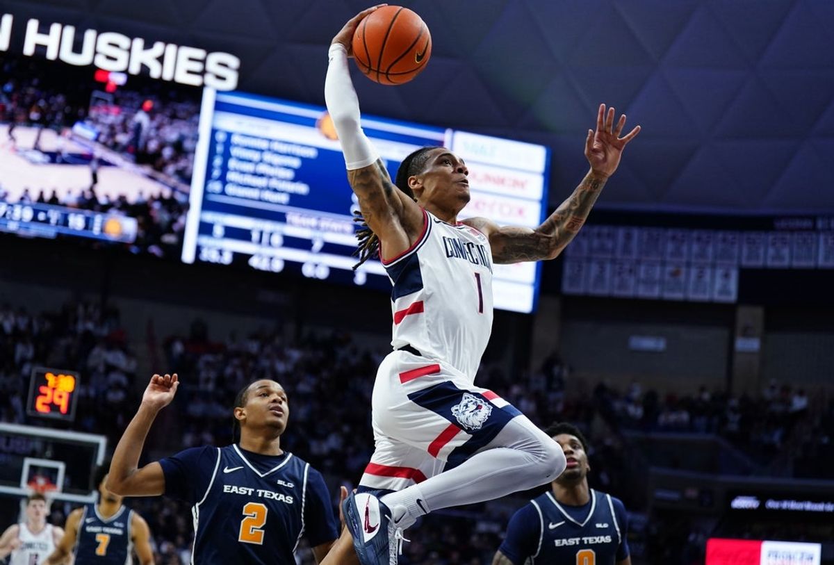 Dec 5, 2025; Storrs, Connecticut, USA; UConn Huskies guard Solo Ball (1) drives the ball to the basket against East Texas A&M Lions guard Evan Phelps (2) in the first half at Harry A. Gampel Pavilion. Mandatory Credit: David Butler II-Imagn Images