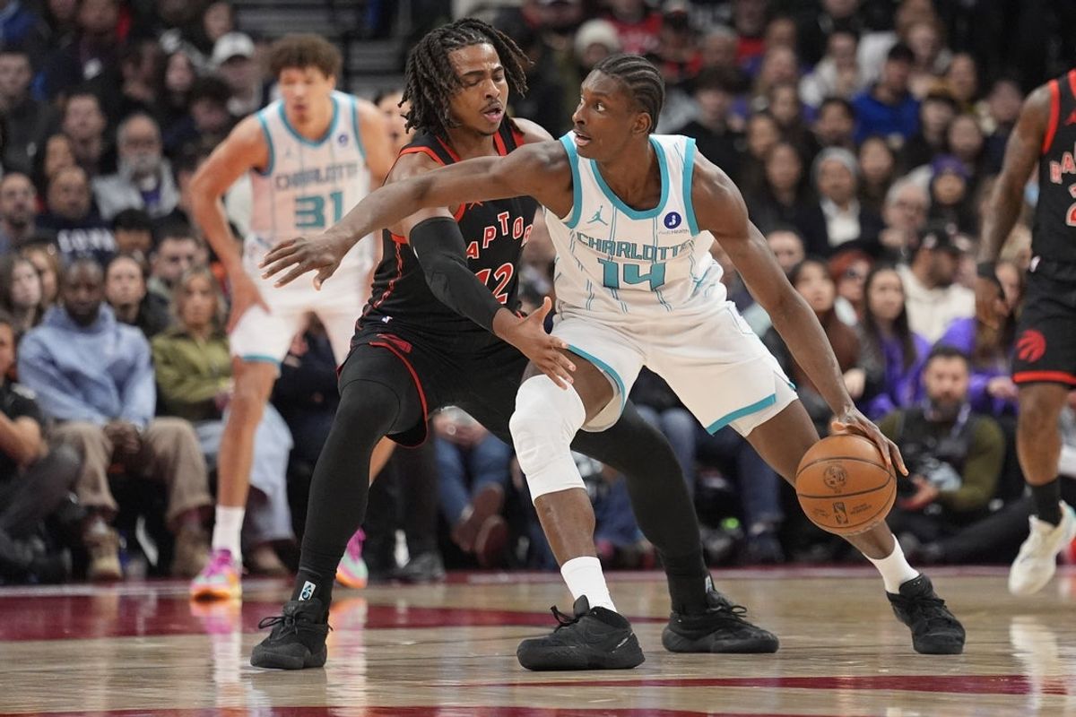 Dec 5, 2025; Toronto, Ontario, CAN; Charlotte Hornets forward Moussa Diabate (14) drives to the net against Toronto Raptors forward Collin Murray-Boyles (12) during the first half at Scotiabank Arena. Mandatory Credit: John E. Sokolowski-Imagn Images