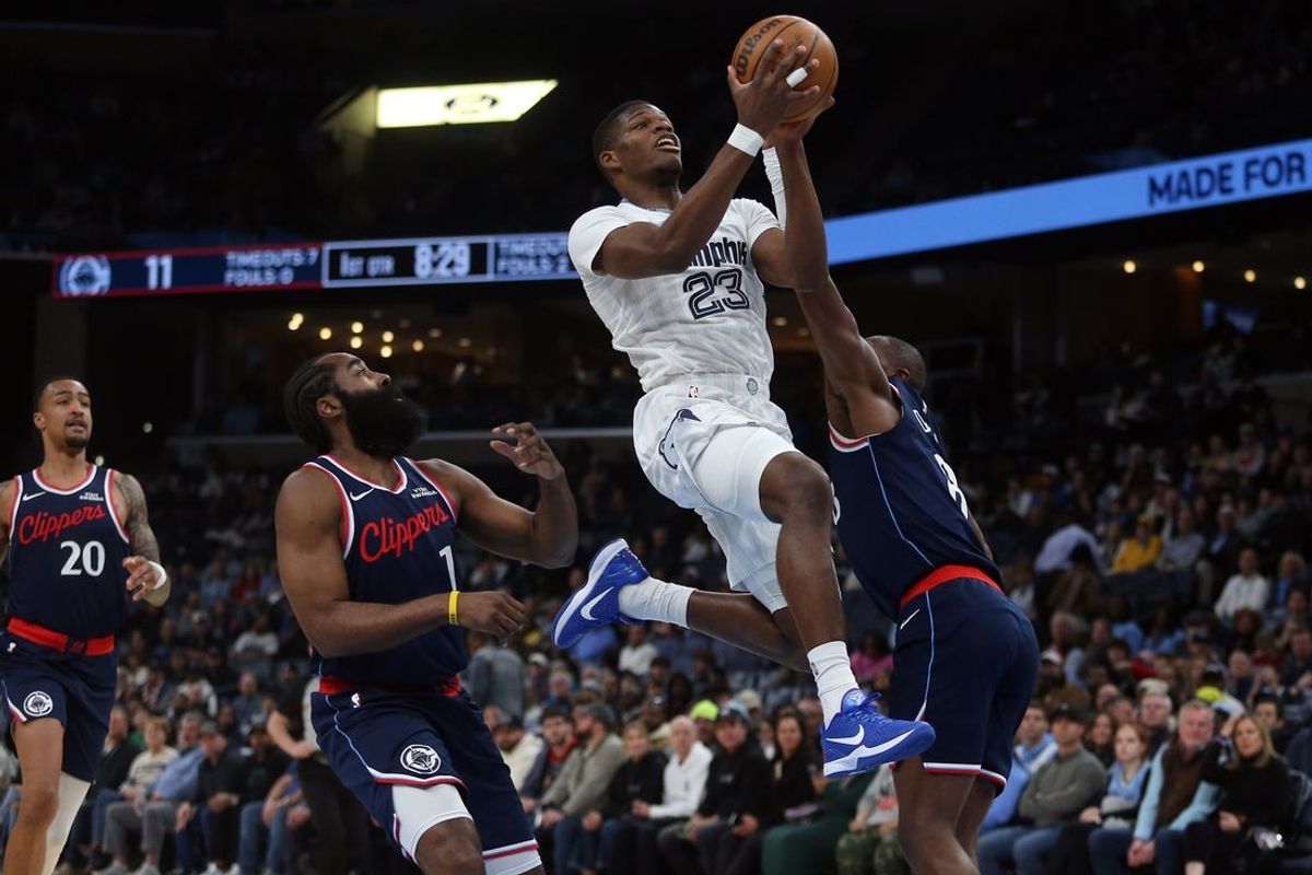 Dec 5, 2025; Memphis, Tennessee, USA; Memphis Grizzlies forward Cedric Coward (23) drives to the basket between guard James Harden (1) and Los Angeles Clippers guard Kris Dunn (8) during the first quarter at FedExForum. Mandatory Credit: Petre Thomas-Imagn Images