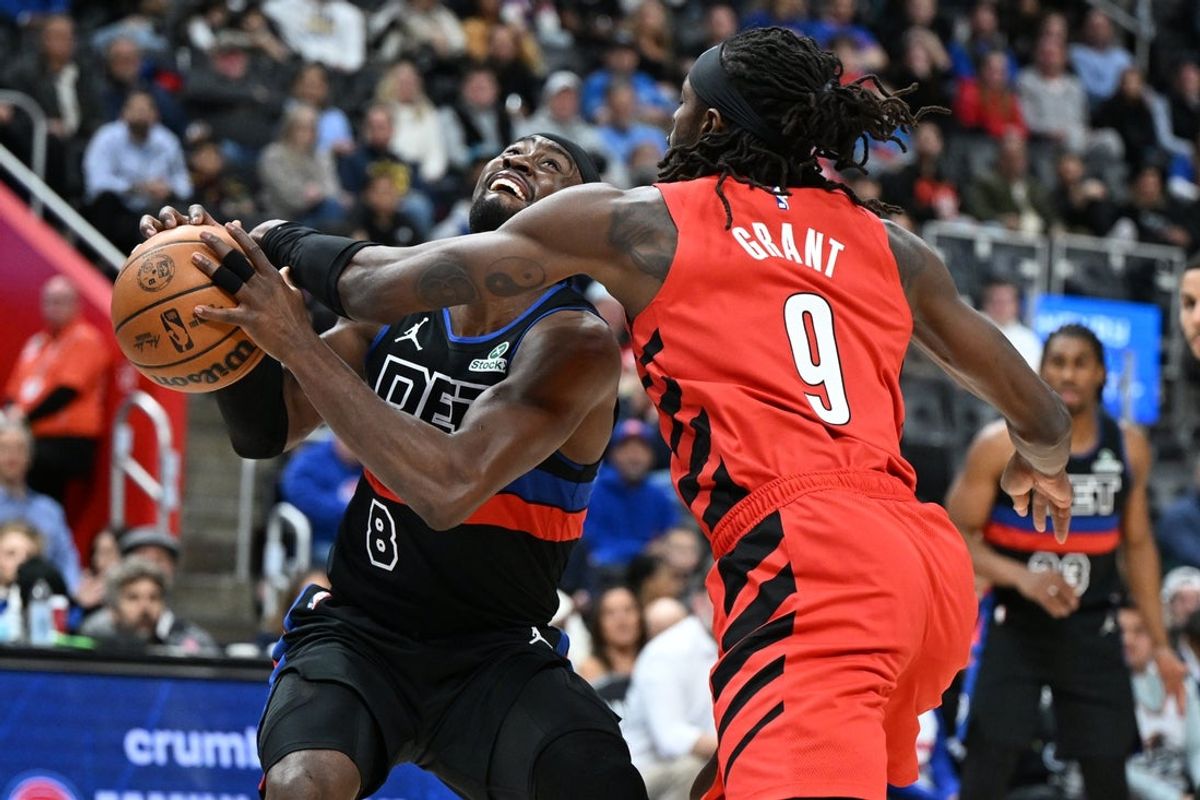 Dec 5, 2025; Detroit, Michigan, USA;  Detroit Pistons guard Caris Levert (8) gets fouled by Portland Trail Blazers forward Jerami Grant (9)  in the first quarter at Little Caesars Arena. Mandatory Credit: Lon Horwedel-Imagn Images