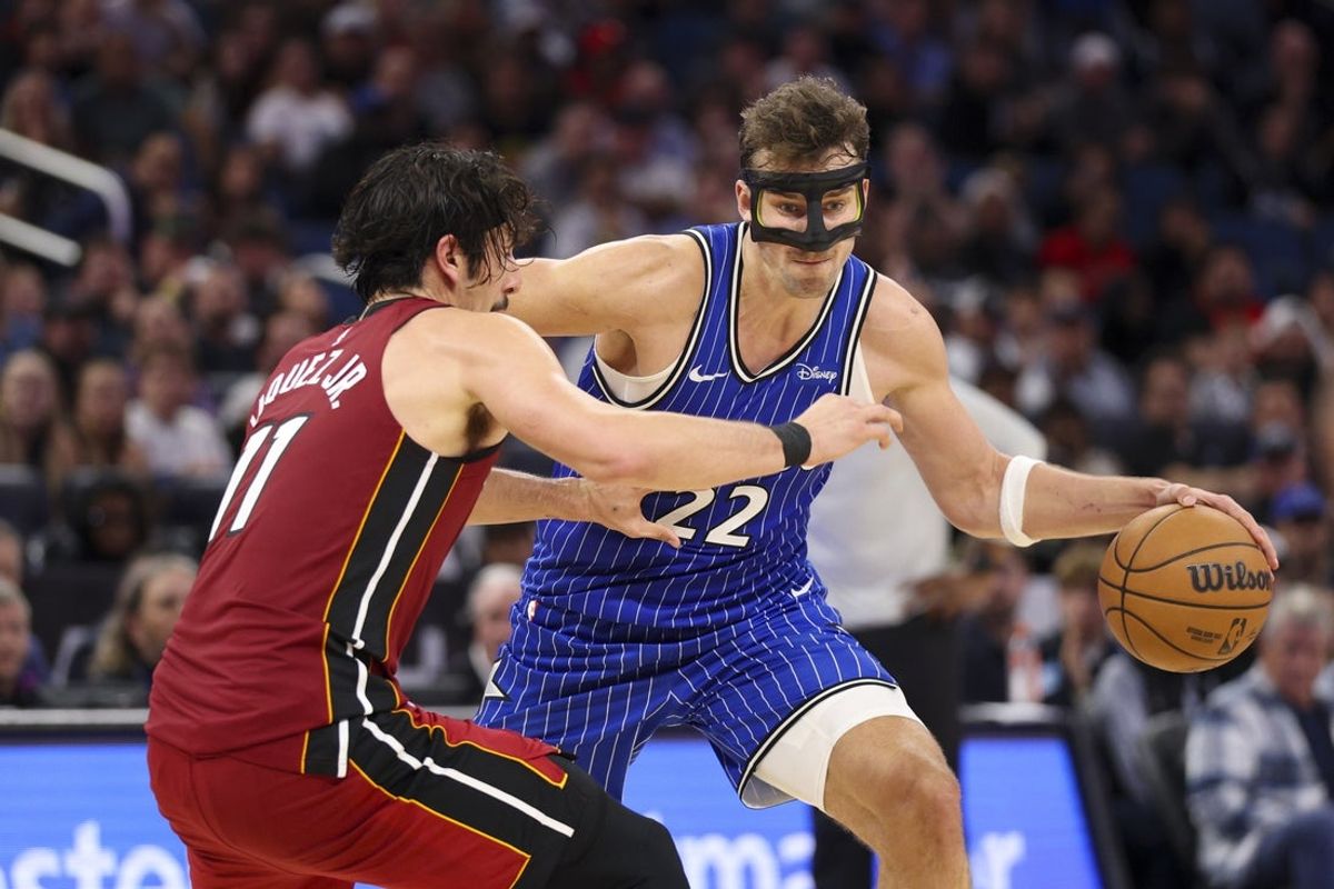 Dec 5, 2025; Orlando, Florida, USA; Orlando Magic forward Franz Wagner (22) drives to the basket past Miami Heat forward Jaime Jaquez Jr. (11) in the fourth quarter at Kia Center. Mandatory Credit: Nathan Ray Seebeck-Imagn Images