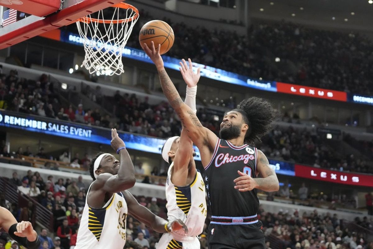 Dec 5, 2025; Chicago, Illinois, USA; Chicago Bulls forward Coby White (0) scores against the Indiana Pacers during the second half at United Center. Mandatory Credit: David Banks-Imagn Images