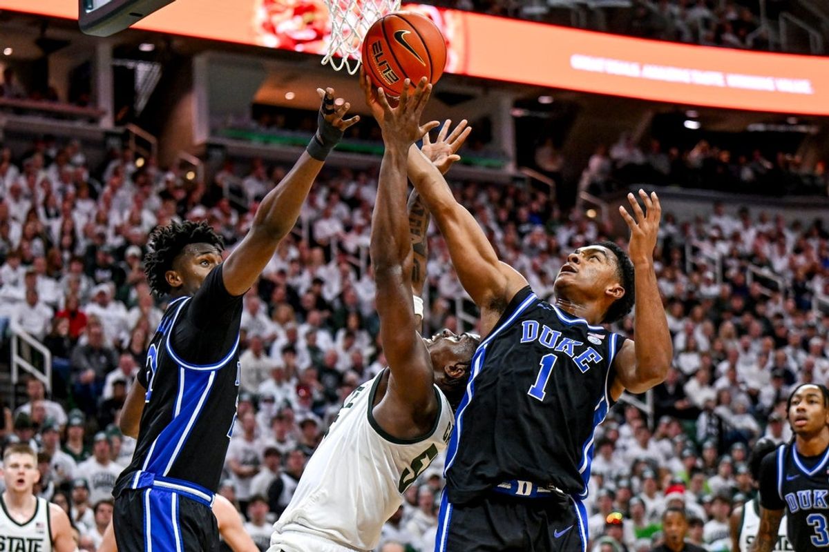 Michigan State's Coen Carr, center, battles Duke's Patrick Ngongba, left, and Caleb Foster for a rebound during the second half on Saturday, Dec. 6, 2025, at the Breslin Center in East Lansing.
