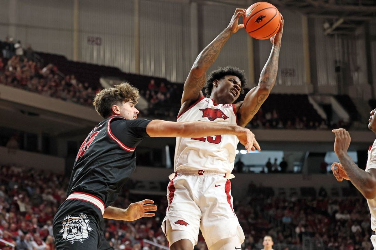Dec 6, 2025; North Little Rock, Arkansas, USA; Arkansas Razorbacks forward Nick Pringle (23) rebounds in the first half against the Fresno State Bulldogs at Simmons Bank Arena. Mandatory Credit: Nelson Chenault-Imagn Images