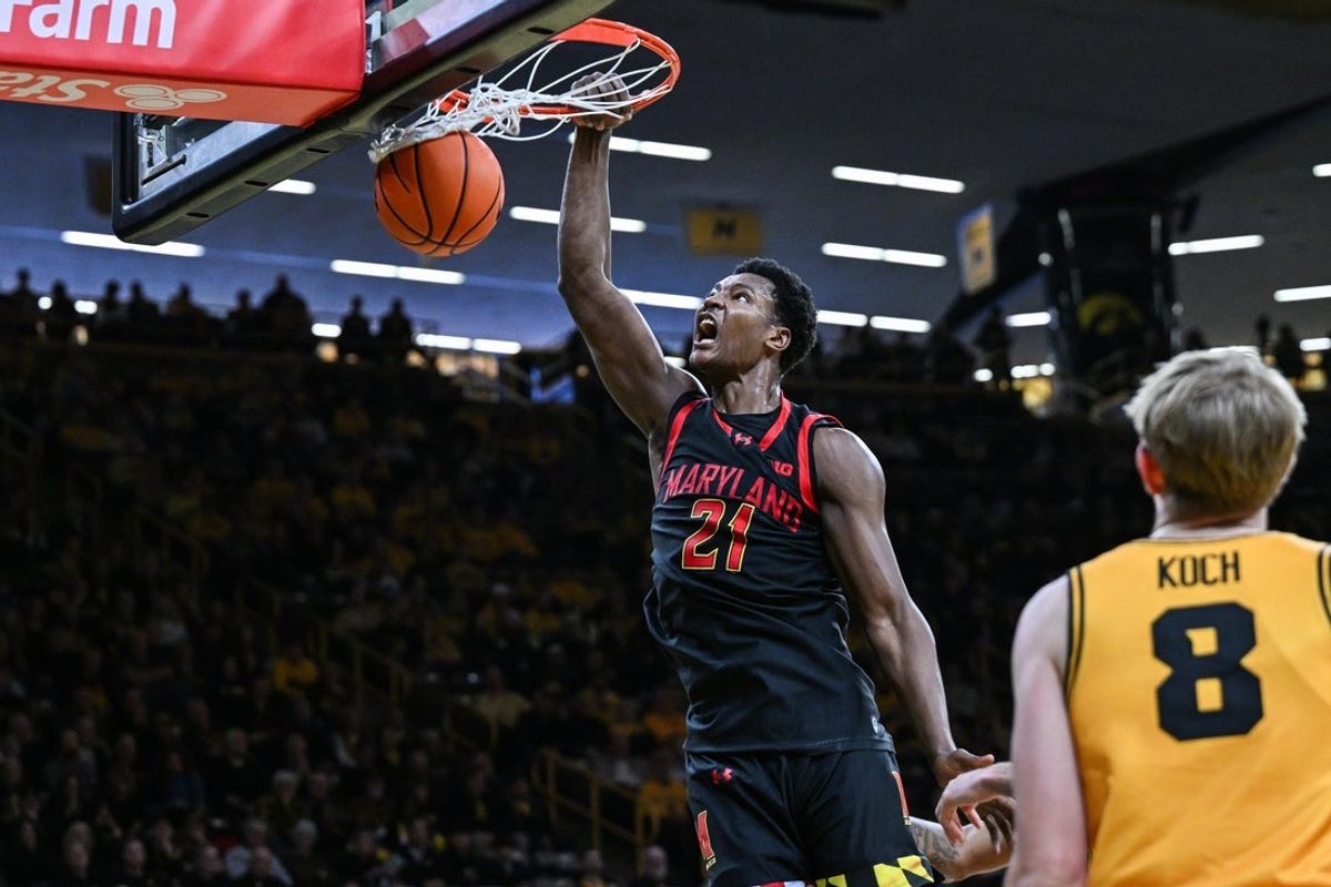 Dec 6, 2025; Iowa City, Iowa, USA; Maryland Terrapins forward Pharrel Payne (21) completes a slam dunk against the Iowa Hawkeyes during the first half at Carver-Hawkeye Arena. Mandatory Credit: Jeffrey Becker-Imagn Images