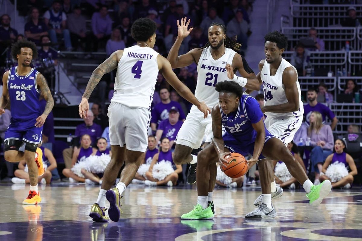 Dec 6, 2025; Manhattan, Kansas, USA; Seton Hall Pirates guard Elijah Fisher (22) keeps the ball away from Kansas State Wildcats guard Mobi Ikegwuruka (14), forward Khamari McGriff (21) and guard P.J. Haggerty (4) during the first half at Bramlage Coliseum. Mandatory Credit: Scott Sewell-Imagn Images