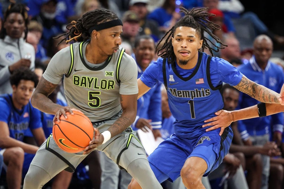 Dec 6, 2025; Memphis, Tennessee, USA; Baylor Bears guard Obi Agbim (5) handles the ball against Memphis Tigers guard Dug McDaniel (1) during the first half at FedExForum. Mandatory Credit: Wesley Hale-Imagn Images