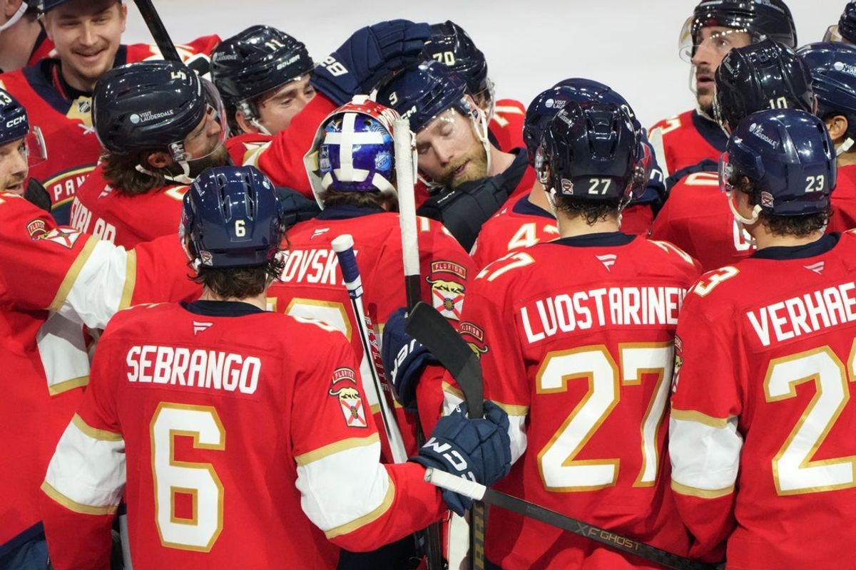 Dec 6, 2025; Sunrise, Florida, USA;  Florida Panthers center Sam Bennett, center, is congratulated by teammates following his winning goal in overtime against the Columbus Blue Jackets at Amerant Bank Arena. Mandatory Credit: Jim Rassol-Imagn Images