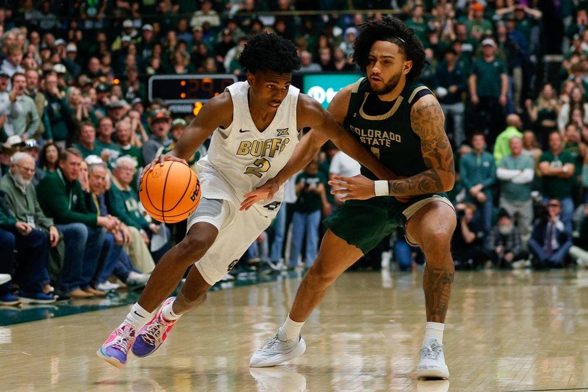 Dec 6, 2025; Fort Collins, Colorado, USA; Colorado Buffaloes guard Isaiah Johnson (2) controls the ball under pressure from Colorado State Rams guard Josh Pascarelli (1) in the second half at Moby Arena. Mandatory Credit: Isaiah J. Downing-Imagn Images