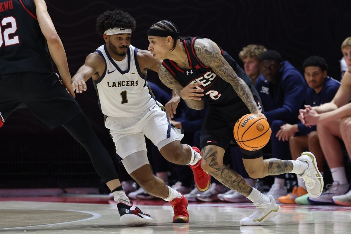 Dec 6, 2025; Salt Lake City, Utah, USA; Utah Utes guard Terrence Brown (2) moves the ball as California Baptist Lancers guard Dominique Daniels Jr. (1) defends during the first half at Jon M. Huntsman Center. Mandatory Credit: Rob Gray-Imagn Images
