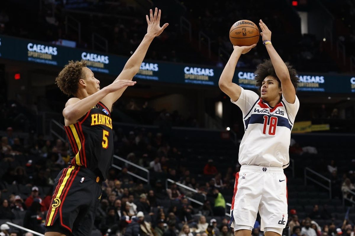 Dec 6, 2025; Washington, District of Columbia, USA; Washington Wizards forward Kyshawn George (18) shoots the ball as Atlanta Hawks guard Dyson Daniels (5) defends in the first half at Capital One Arena. Mandatory Credit: Geoff Burke-Imagn Images