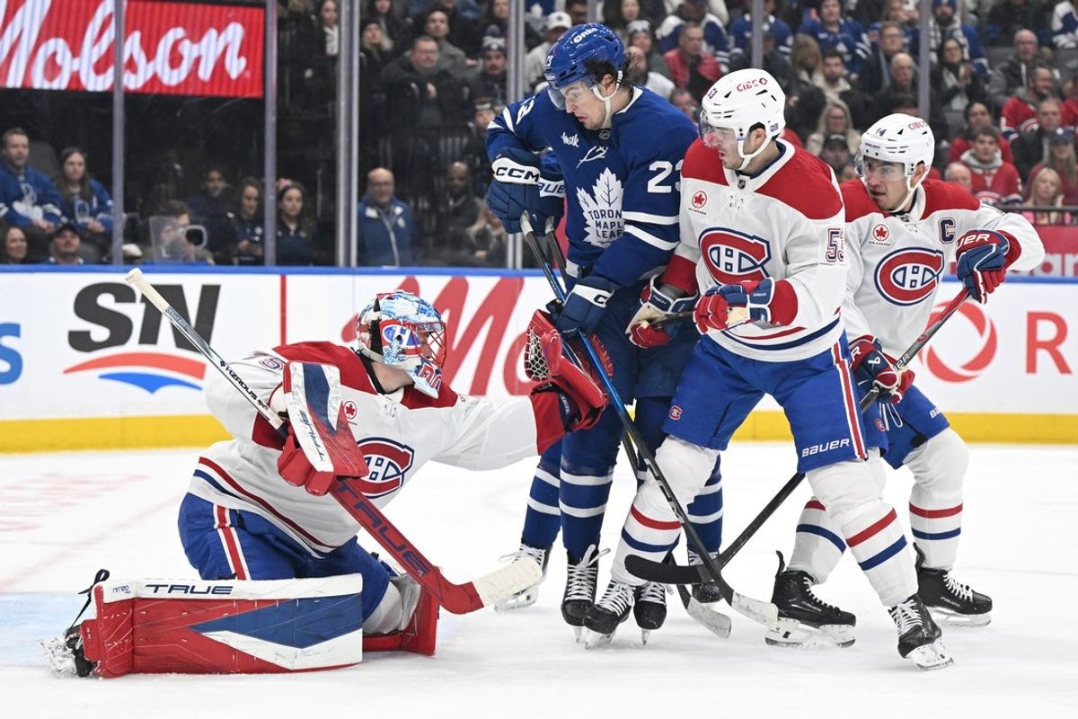 Dec 6, 2025; Toronto, Ontario, CAN;  Montreal Canadiens goalie Jakub Dobes (75) makes a glove save as defenseman Noah Dobson (53) covers Toronto Maple Leafs forward Matthew Knies (23) in the first period at Scotiabank Arena. Mandatory Credit: Dan Hamilton-Imagn Images
