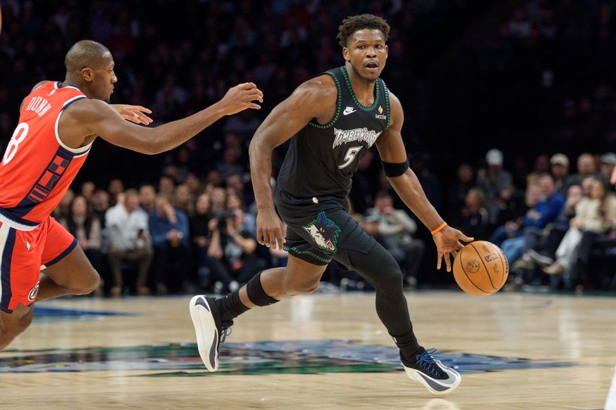 Dec 6, 2025; Minneapolis, Minnesota, USA; Minnesota Timberwolves guard Anthony Edwards (5) brings the ball up the court by the defense oft LA Clippers guard Kris Dunn (8) in the first quarter at Target Center. Mandatory Credit: Matt Blewett-Imagn Images