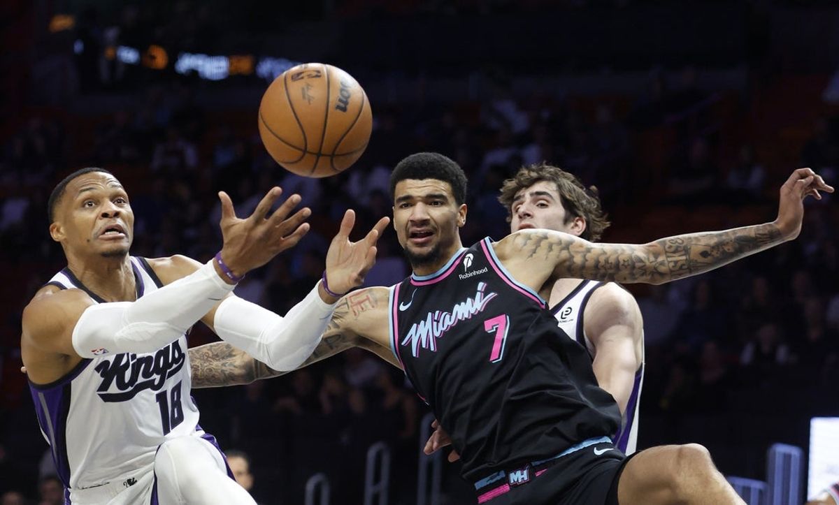 Dec 6, 2025; Miami, Florida, USA;   Sacramento Kings guard Russell Westbrook (18) and Miami Heat center Kel'el Ware (7) go for a rebound during the first half at Kaseya Center. Mandatory Credit: Rhona Wise-Imagn Images