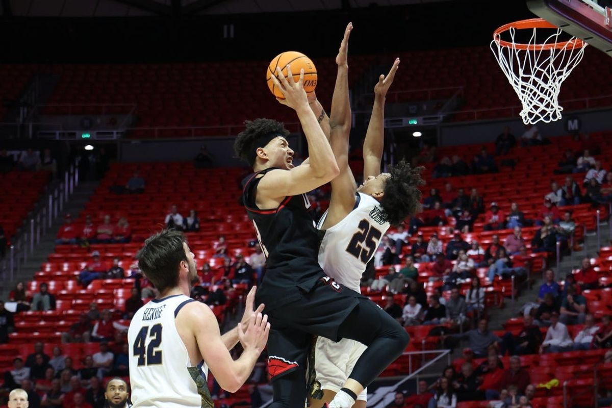 Dec 6, 2025; Salt Lake City, Utah, USA; Utah Utes forward James Okonkwo (32) prepares to shoot against California Baptist Lancers forward Bradey Henige (42) and forward Thomas Ndong (25) during the second half at Jon M. Huntsman Center. Mandatory Credit: Rob Gray-Imagn Images