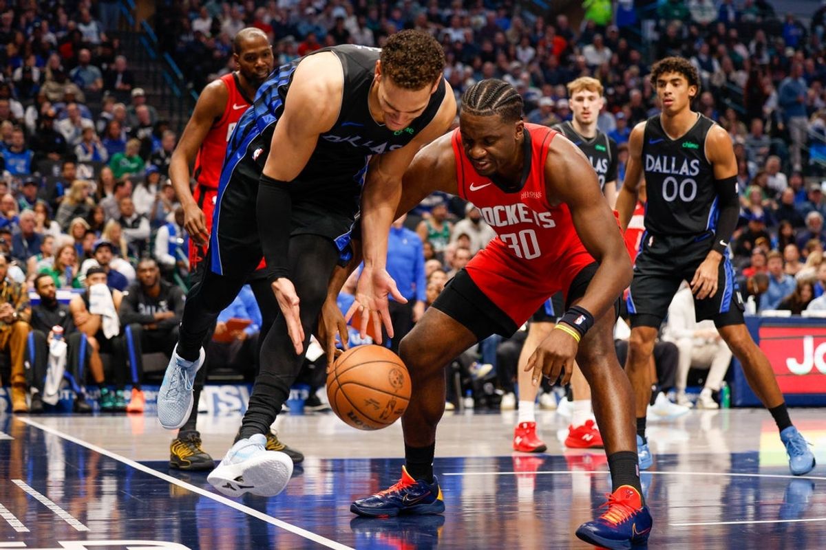 Dec 6, 2025; Dallas, Texas, USA; Dallas Mavericks forward Dwight Powell (7) and Houston Rockets center Clint Capela (30) fight for the ball during the second quarter at American Airlines Center. Mandatory Credit: Andrew Dieb-Imagn Images