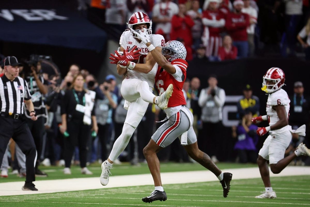 Dec 6, 2025; Indianapolis, IN, USA; Indiana Hoosiers wide receiver Charlie Becker (80) makes a catch against Ohio State Buckeyes cornerback Devin Sanchez (6) in the second quarter during the 2025 Big Ten championship game at Lucas Oil Stadium. Mandatory Credit: Trevor Ruszkowski-Imagn Images
