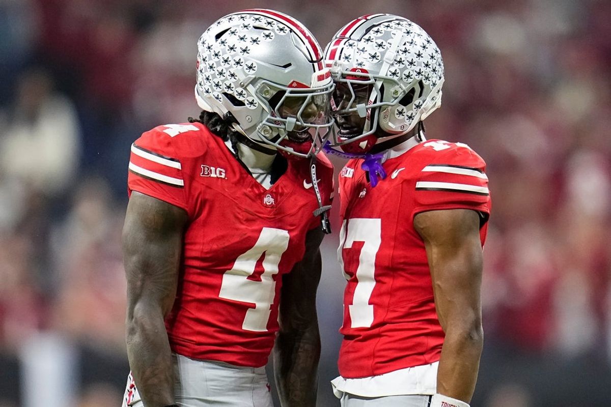 Ohio State Buckeyes wide receiver Jeremiah Smith (4) celebrates with wide receiver Carnell Tate (17) during the first half of the Big Ten Conference championship game against the Indiana Hoosiers at Lucas Oil Stadium in Indianapolis on Dec. 6, 2025.