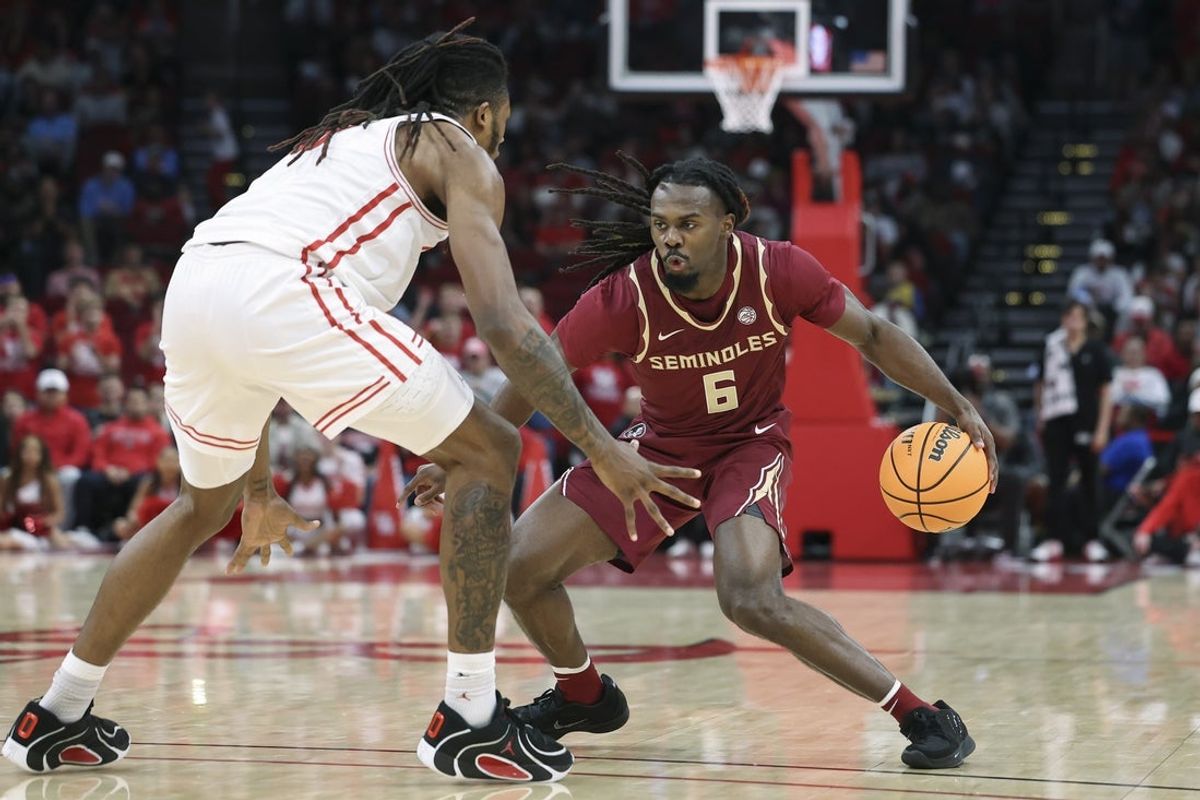 Dec 6, 2025; Houston, TX, USA; Florida State Seminoles guard Robert McCray V (6) dribbles the ball as Houston Cougars forward Joseph Tugler (11) defends during the second half at Toyota Center. Mandatory Credit: Troy Taormina-Imagn Images