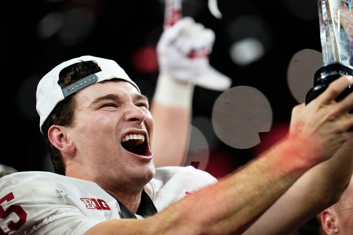 Indiana Hoosiers quarterback Fernando Mendoza (15) celebrates with the MVP trophy following the Big Ten Conference championship game against the Ohio State Buckeyes at Lucas Oil Stadium in Indianapolis on Dec. 6, 2025. Ohio State lost 13-10.